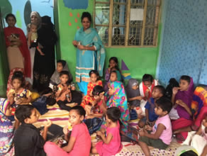 Photo-1: Children studying on the floor and eating cookies