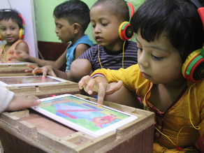 Photo-2: Refugee children studying on tablets