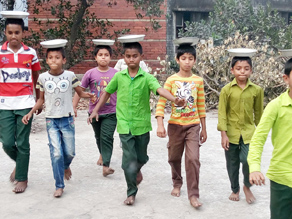 Photo-8: Children relaying with plates on their heads in the schoolyard