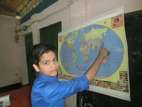 Photo-9: A child confirming the position of Japan on a world map