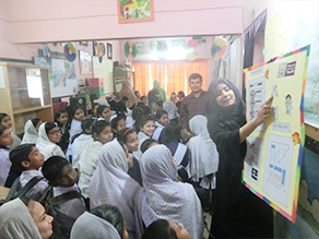 Photo-4: Local staff teaching how to brush teeth using posters