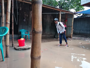 Photo-3: A child arriving at school and having his feet soaked