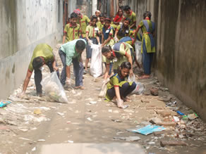 Photo-6: Children picking up garbage around the school building