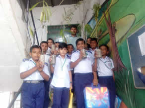Photo-6: Principal Monil distributing seedlings to children