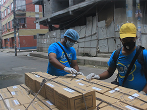 Photo-1: Volunteers packing cookies for distribution