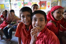 Smiles of children eating cookies