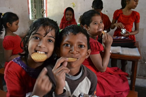 A child eating deliciously with a smile